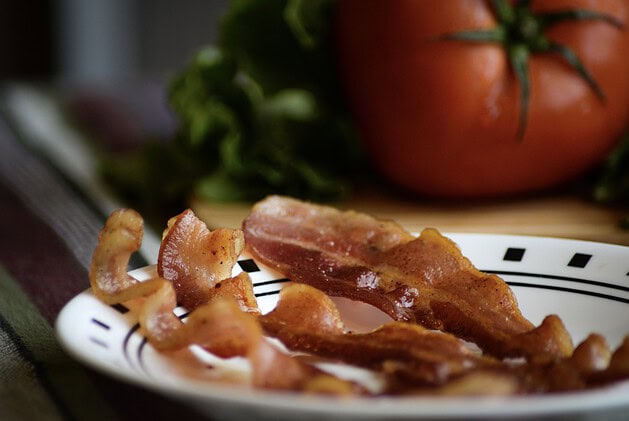 Crispy cooked bacon strips on a plate