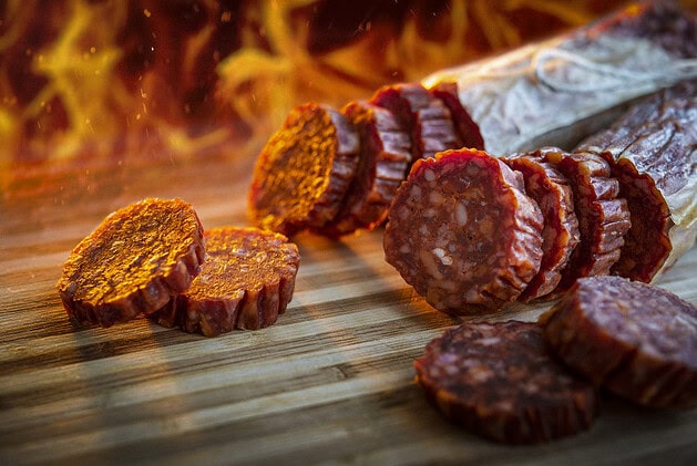 Sliced hot salami on a cutting board