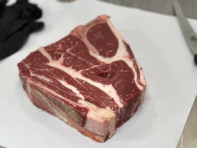 Raw bone-in beef short ribs on butcher paper