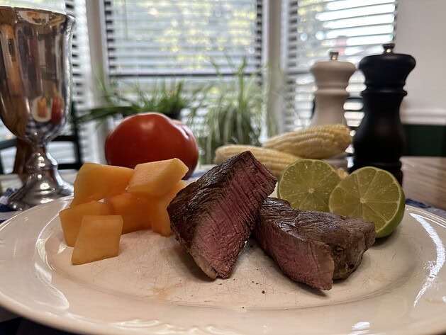 Plated sliced filet mignon with sides