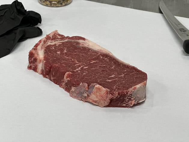 Raw New York strip steak on butcher paper