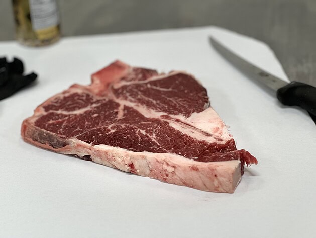Raw porterhouse steak on butcher paper
