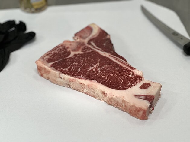 Raw T-bone steak on butcher paper